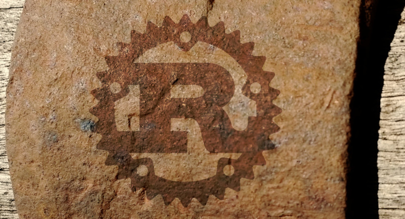 Rust logo on rust coloured background